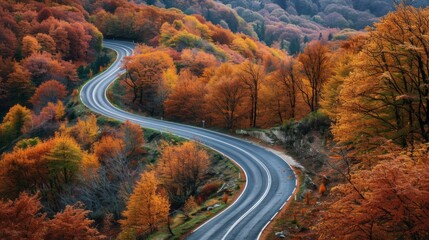 Winding road with colorful autumn trees in the mountains generative ai