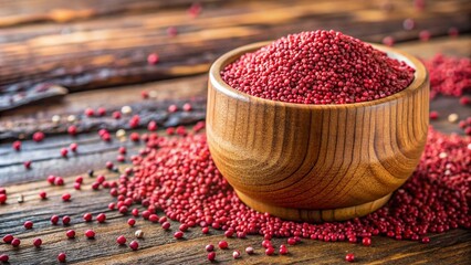 a rustic wooden cup filled with vibrant red amaranth grains, the bright color of the grains standing