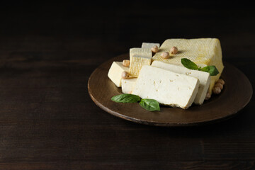 Wall Mural - Tofu in a wooden bowl on a dark background