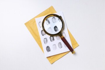 Wall Mural - Magnifying glass with fingerprints on a white background