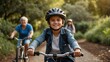 © LIFE LINE - A young boy wearing a safety helmet and riding his bike on the path with family in the background, smiling at the camera