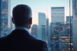 © lashkhidzetim - man in a suit is looking out a window at the city skyline. Concept of contemplation and reflection, as the man gazes out at the bustling city below