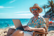 © lashkhidzetim - man is sitting on a beach with a laptop and a straw hat on. He is smiling and he is enjoying his time