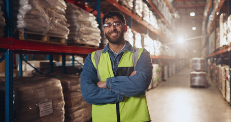 Canvas Print - Portrait, arms crossed and man with smile in factory, glasses or proud of supply chain or shipping. Logistics, vision and employee in warehouse for storage of stock, cargo or service of manufacturing