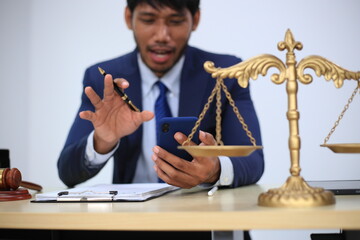 Asian male lawyer reading time limit law, giving advice, tax office, law firm, judge, legal advisor, lawyer working in office, judge knocking wood with lawyer for justice, contract