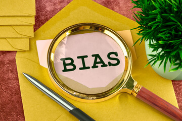 Wall Mural - Business concept. The word Bias written through a magnifying glass in a letter peeking out of an envelope