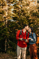 Wall Mural - Bonding couple exploring the nature and using a drone to take a photos and videos