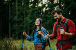 © La Famiglia - The hiking couple follow the trail along the forest ridge