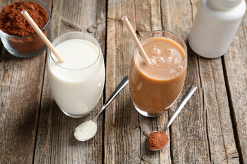 Poster - Delicious protein shakes in glasses and spoons with powder on wooden table