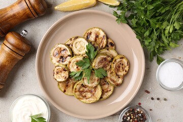 Wall Mural - Tasty grilled courgette slices served on grey textured table, flat lay