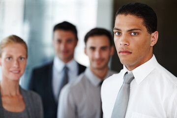 Lawyers, office and portrait of man with business people for teamwork, collaboration and legal career. Corporate attorney, law firm and workers with confidence, serious and meeting for company pride