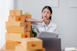 © David - Young asian online seller businesswoman working shipping at home for online orders and thinking about her sme business future, good for online seller business sme concept.