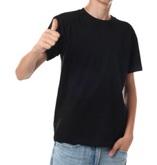 Wall Mural - Teenage boy wearing black t-shirt and showing thumbs up on white background, closeup