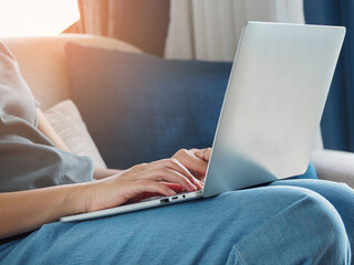 Wall Mural - a young woman's hand working on a laptop