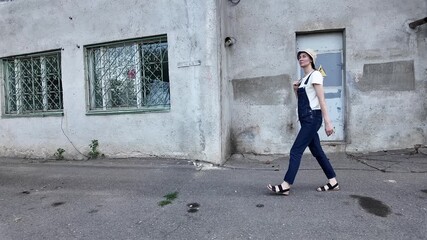 Wall Mural - Woman walking in the city with tote eco white bag