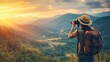 © arhendrix - Traveler wearing a hat and backpack takes a photo of a beautiful sunset over forested mountains. Adventure and nature concept.