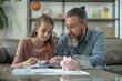 © Anna - Father with gray beard helping daughter with homework at home while using calculator on the coffee table. This image highlights family bonding, education, and parental involvement in learning.