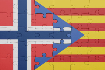 puzzle with the colourful national flag of catalonia and flag of norway .