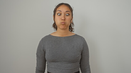 Sticker - A young hispanic woman with a playful expression stands isolated against a white background, epitomizing beauty and youth.