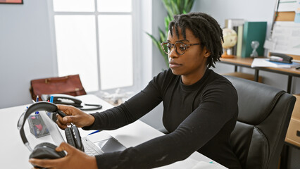 Sticker - African american woman with dreadlocks working in an office with a computer and headphones