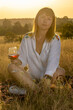 © Олег Мальшаков - Beautiful young girl with a glass of wine on a picnic