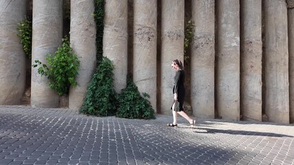 Sticker - Woman walking in the city wearing elegant black dress