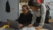 © Krakenimages.com - Two women investigators analyze documents and a laptop in a police department office setting, implying a focused investigation.