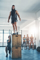 Wall Mural - Box jump, fitness and man at gym in exercise class with cheer and applause for workout success. Determination, sport and athlete at wellness and health club with strength and circuit training