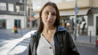 © Krakenimages.com - Portrait of a beautiful young brunette woman outdoors on a sunny urban street.