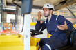 © offsuperphoto - Engineer or worker talking on walkie talkie and driving a car in the factory