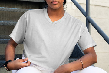 Wall Mural - Png crop tee mockup worn by a woman sitting on the stairs