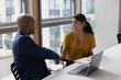 © ReeldealHD images - Business persons handshake in a modern office with views of buildings
