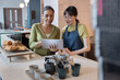 © ReeldealHD images - Cafe business owner training an employee