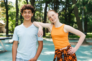 portrait of happy teenagers friends standing in the park