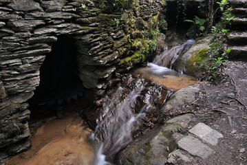 Small waterfall from a stream with an entrance to an old mill, river, water mill