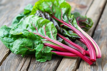 Close up image of fresh chard leaves on wooden table