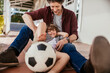© Marko Geber - Father and son playing with soccer ball on porch