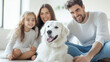 © Denis Yevtekhov - Happy family moments with their dog, parents and daughter sitting on the floor, cheerful and affectionate, modern and comfortable living room, with copy space