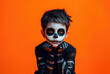© Karat - Child with detailed skull makeup, dressed in a skeleton costume, set against a vivid orange background. This striking and spooky image is perfect for Halloween, themed events, and creative photography