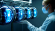 © Rossarin - A female scientist in a lab coat and face mask monitors glowing equipment.