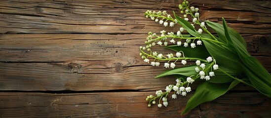 Poster - Lily of the valley bouquet on aged wooden table background with copy space image