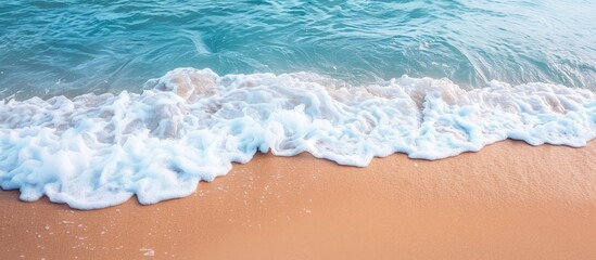 Aufkleber - Sandy beach in summertime with gentle waves and white foam ideal as copy space image for travel themes