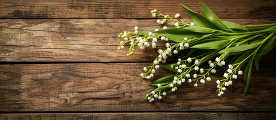 Poster - Lily of the valley bouquet on aged wooden table background with copy space image