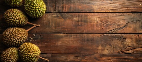 Poster - Wooden background with ripe durians ideal for a banner design with copy space image