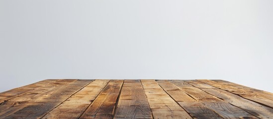 Wall Mural - Front view of an empty wooden table with a white background perfect for incorporating a copy space image