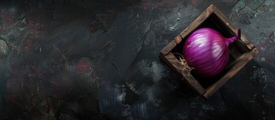 Poster - Top view of a purple onion in a wooden box on a black background with ample space for additional images