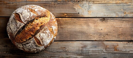 Poster - Top view of a homemade buckwheat bread loaf on a wooden surface with a blank area for text or images. Creative banner. Copyspace image
