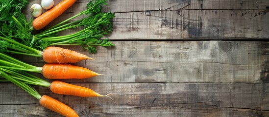 Poster - Fresh carrot and spring onion on a wooden table surface with copy space image