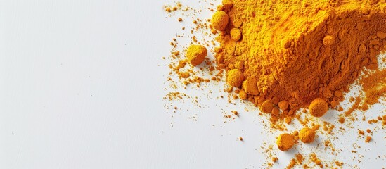 Wall Mural - Turmeric powder displayed on a white background with ample copy space image in a top down perspective