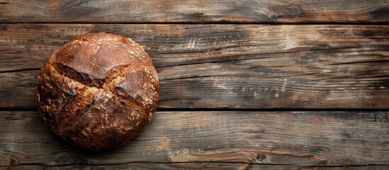 Poster - Top view of a homemade buckwheat bread loaf on a wooden surface with a blank area for text or images. Creative banner. Copyspace image